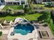 Aerial view of a backyard pool and spa with a well-maintained lawn and privacy fence at 3531 E Norwood Cir, Mesa, AZ 85213