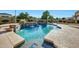 Sparkling pool with a waterfall feature and a charming dolphin mosaic, perfect for relaxation and outdoor fun at 3531 E Norwood Cir, Mesa, AZ 85213