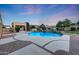 Backyard pool featuring custom waterfall feature, desert landscaping, and adjacent covered structure at 3531 E Norwood Cir, Mesa, AZ 85213
