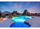 Backyard pool with mosaic dolphin and stone accents, featuring a waterfall feature and ambient lighting for a peaceful retreat at 3531 E Norwood Cir, Mesa, AZ 85213