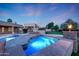 Backyard pool with a hot tub, lush landscaping, and a covered ramada, creating a serene outdoor oasis at 3531 E Norwood Cir, Mesa, AZ 85213