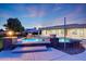 Sparkling pool and spa with custom stone accents, lush landscaping, and elegant architectural design at 3531 E Norwood Cir, Mesa, AZ 85213