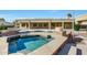Inviting spa with stone detailing, perfect for relaxation alongside the sparkling pool and well-maintained landscaping at 3531 E Norwood Cir, Mesa, AZ 85213