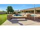 Relaxing spa with stone accents, complemented by a refreshing pool and lush green lawn for serene outdoor living at 3531 E Norwood Cir, Mesa, AZ 85213