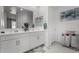 Bright bathroom features double sinks with stylish mirrors and cabinets at 36284 W San Clemente Ave, Maricopa, AZ 85138