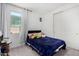 Cozy bedroom with a twin bed, window, and closet at 36284 W San Clemente Ave, Maricopa, AZ 85138