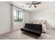 Bright bedroom includes a window providing natural light, carpet flooring, and a ceiling fan at 36284 W San Clemente Ave, Maricopa, AZ 85138