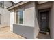 Close-up of a modern home's front door and window with desert landscaping at 36284 W San Clemente Ave, Maricopa, AZ 85138