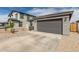Suburban home featuring a two-car garage and low-maintenance desert landscaping at 36284 W San Clemente Ave, Maricopa, AZ 85138
