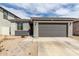 Inviting single-story home with a two-car garage and stone walkway leading to the entrance at 36284 W San Clemente Ave, Maricopa, AZ 85138