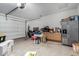 Spacious garage featuring ample storage and refrigerator at 36284 W San Clemente Ave, Maricopa, AZ 85138