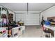 Cluttered garage with plenty of storage space and an automatic door at 36284 W San Clemente Ave, Maricopa, AZ 85138