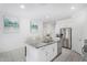 Bright kitchen features granite counters, stainless steel appliances, and tiled floors at 36284 W San Clemente Ave, Maricopa, AZ 85138