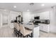 Bright, modern kitchen featuring stainless steel appliances, granite countertops, and an island with seating at 36284 W San Clemente Ave, Maricopa, AZ 85138