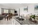Open-concept kitchen with granite countertops and a view into the cozy living area at 36284 W San Clemente Ave, Maricopa, AZ 85138