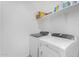 Clean, white laundry room features modern washer and dryer units at 36284 W San Clemente Ave, Maricopa, AZ 85138