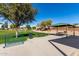 Park featuring a shaded picnic area, benches, and a grassy area with a soccer net at 36284 W San Clemente Ave, Maricopa, AZ 85138