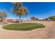 Well-maintained community park with a putting green, playground, and picnic areas at 36284 W San Clemente Ave, Maricopa, AZ 85138
