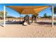 Covered playground with slides and ladders on a sandy play area at 36284 W San Clemente Ave, Maricopa, AZ 85138