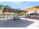 Community park with a shaded picnic area, playground with slides, and swings for Gathering enjoyment and community gatherings at 36284 W San Clemente Ave, Maricopa, AZ 85138