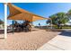 Community playground featuring slides, swings, and climbing equipment under a shaded canopy at 36284 W San Clemente Ave, Maricopa, AZ 85138