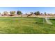 Community recreation area with a playground, picnic area, and large grassy field at 36284 W San Clemente Ave, Maricopa, AZ 85138