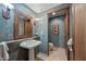 This bathroom features a unique sink with a beautiful mirror and an open door to the toilet at 36601 N Mule Train Rd # 40A, Carefree, AZ 85377