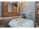 Bathroom features a large mirror, modern faucet, and neutral color palette at 36601 N Mule Train Rd # 40A, Carefree, AZ 85377