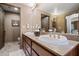 Bathroom with dual sinks and a spacious vanity, offering ample counter space at 36601 N Mule Train Rd # 40A, Carefree, AZ 85377