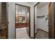 En-suite bathroom with dual sinks and a large mirror viewed from bedroom doorway at 36601 N Mule Train Rd # 40A, Carefree, AZ 85377