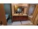 Bright bathroom featuring double sinks with cabinets and a bathtub with shower at 36601 N Mule Train Rd # 40A, Carefree, AZ 85377