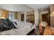 Comfortable bedroom featuring two beds with unique patterned linens, a wooden storage cabinet, and a desk at 36601 N Mule Train Rd # 40A, Carefree, AZ 85377
