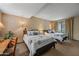 Comfortable bedroom featuring two beds, soft lighting and a relaxing atmosphere at 36601 N Mule Train Rd # 40A, Carefree, AZ 85377
