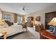 Bedroom featuring a bed, wood furniture and a view to the exterior at 36601 N Mule Train Rd # 40A, Carefree, AZ 85377
