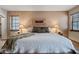 Cozy bedroom with soft lighting, a luxurious bed, and decorative wall art at 36601 N Mule Train Rd # 40A, Carefree, AZ 85377