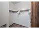 A bright, empty walk-in closet with a single clothes rod is ready for customization at 36601 N Mule Train Rd # 40A, Carefree, AZ 85377
