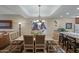 Spacious dining room features a chandelier, and a large Native American Art piece on the wall at 36601 N Mule Train Rd # 40A, Carefree, AZ 85377