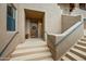 Inviting front entrance with decorative wooden door, wreath, and steps leading to the home at 36601 N Mule Train Rd # 40A, Carefree, AZ 85377
