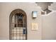 Elegant wrought iron gate leading to the front entrance, enhancing the property's curb appeal at 36601 N Mule Train Rd # 40A, Carefree, AZ 85377