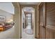 Hallway with arched doorways, leading to the bathroom and living room at 36601 N Mule Train Rd # 40A, Carefree, AZ 85377