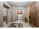 Hallway with a large wooden door and view to the laundry room and another room at 36601 N Mule Train Rd # 40A, Carefree, AZ 85377
