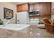 Bright kitchen featuring a stainless steel microwave, white refrigerator and oven range at 36601 N Mule Train Rd # 40A, Carefree, AZ 85377