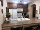 This kitchen offers a spacious breakfast bar, ample cabinets, and essential appliances at 36601 N Mule Train Rd # 40A, Carefree, AZ 85377