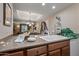 Inviting kitchen featuring warm wood cabinets, granite counters, and an open layout to the living area at 36601 N Mule Train Rd # 40A, Carefree, AZ 85377