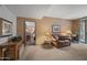 Living Room featuring leather furniture, and an open doorway to the dining room at 36601 N Mule Train Rd # 40A, Carefree, AZ 85377