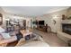 Comfortable living room with a large leather sofa, fireplace, and view of the dining area at 36601 N Mule Train Rd # 40A, Carefree, AZ 85377