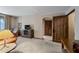Spacious living room featuring comfortable leather seating, a TV, and access to a hallway at 36601 N Mule Train Rd # 40A, Carefree, AZ 85377