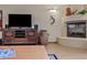 Cozy living room featuring a fireplace, entertainment center and tasteful Southwestern decor at 36601 N Mule Train Rd # 40A, Carefree, AZ 85377