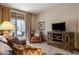 Comfortable living room with cozy leather furniture and a view of the outdoor patio at 36601 N Mule Train Rd # 40A, Carefree, AZ 85377