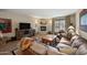 Open living room with fireplace, leather furniture, and a view to the exterior at 36601 N Mule Train Rd # 40A, Carefree, AZ 85377